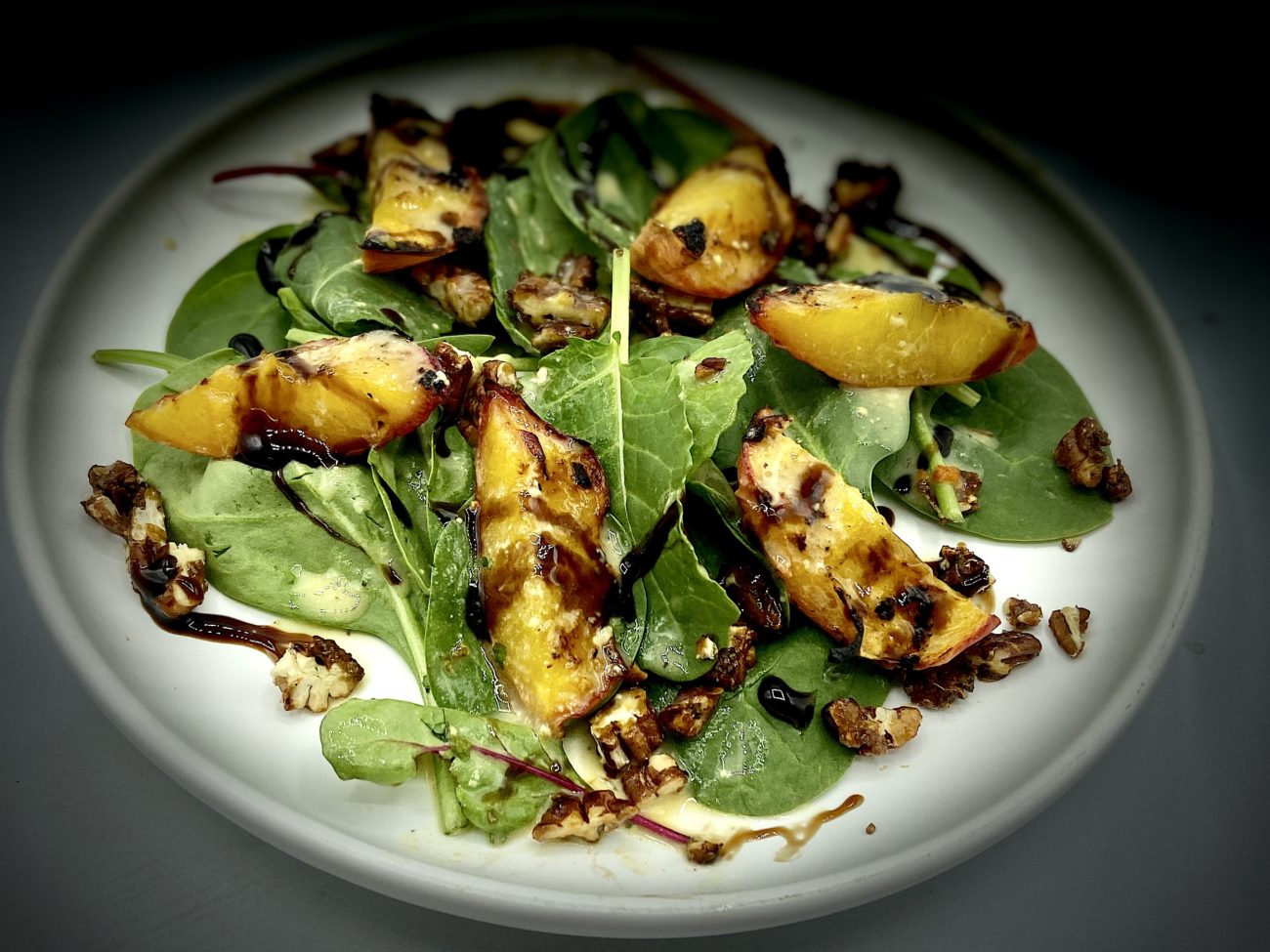 Grilled Peach Salad with Caramelized Pecans and Chili Dressing